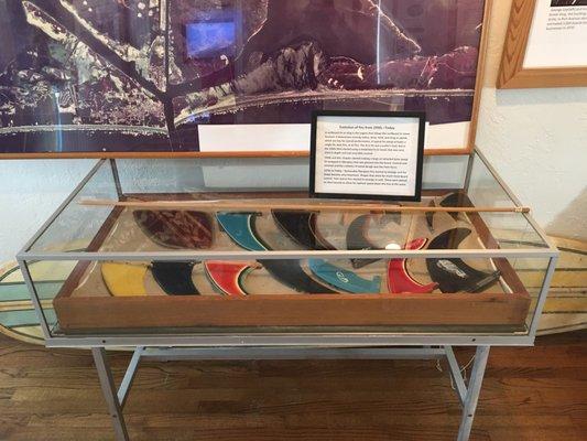 The evolution of surfboard fins, part of the Surfing Exhibit.