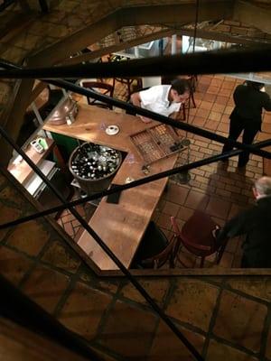 Old men at game of traditional backgammon. With center top floor view.