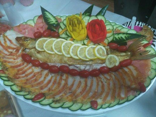 Sliced sable, lox and fresh white fish salad platter.