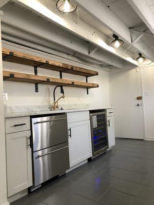 New wet bar with exposed ceiling and industrial lights