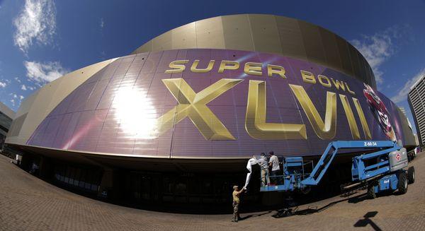 Super Bowl graphics wrap installation by CCI on Superdome facade.