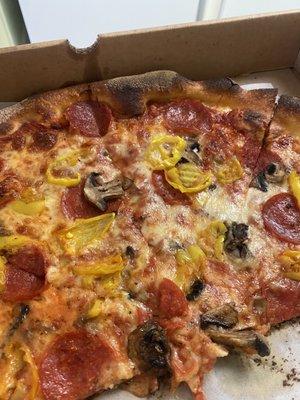 This is an extra baked pie with pepperoni, mushroom, and banana peppers. Try not to lick your cell phone screen.