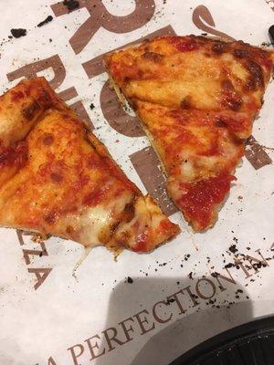 Cheese only on the very tips of these two slices.  Black crumbs from other burned slices.  yuck.