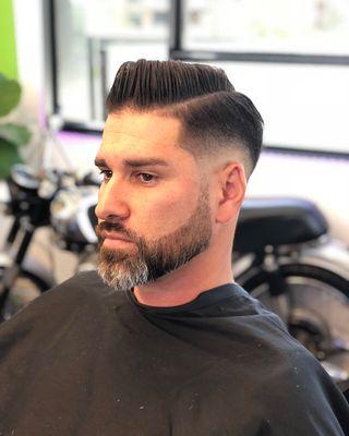 Medium low skin fade with beard line up