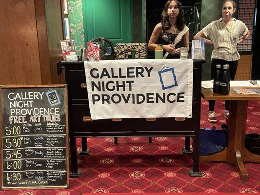 Check-in podium with a Gallery Night banner near the main entrance