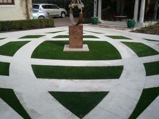 Concert driveway with artificial turf inlays.