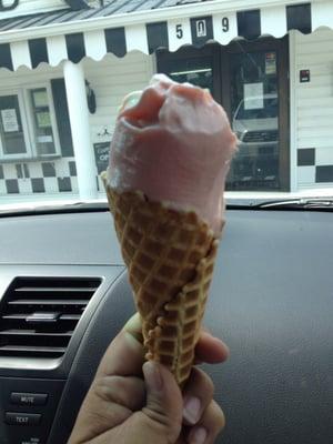 Strawberry frozen custard in a freshly made waffle cone