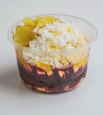 Aloha Tropical Acai bowl is made with Acai Sorbet, Pineapple, Bananas, Coconut flakes, and honey drizzle.