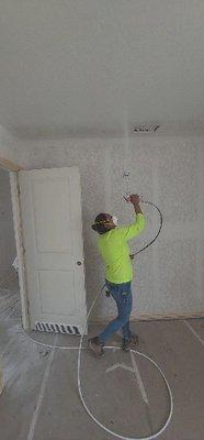 Brenda spraying ceilings for Lennar Homes in San Antonio, Texas.