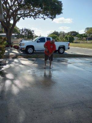 The King power washing a driveway