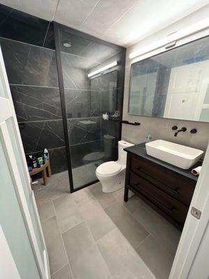 Renovated Restroom - walk-in shower with nice black halo lined shower glass