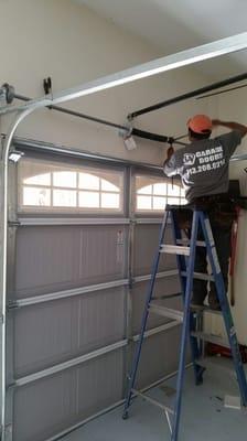 Technician replace garage broken spring.