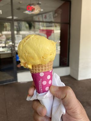 Triple Mango ice cream on a sugar cone.