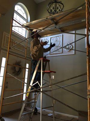 Installing a chandelier using scaffolding