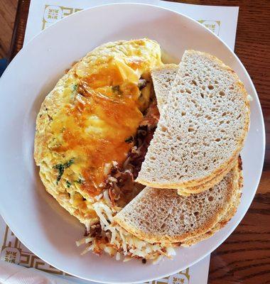 Mushroom omelette with crispy hash browns and sour dough