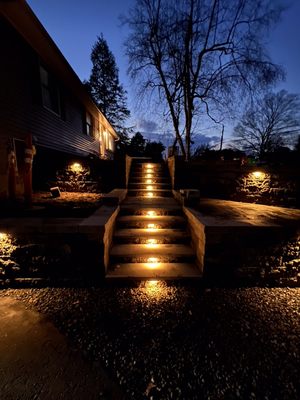 Retaining walls, steps with bluestone, low voltage lighting, and a paver walkway installation