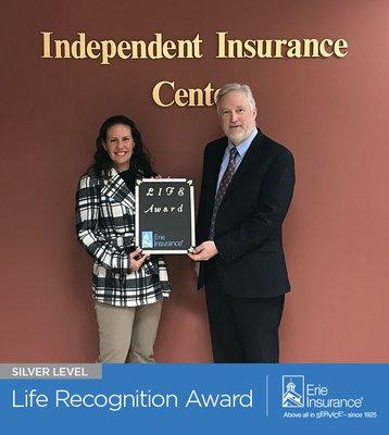 Independent Insurance Center, located in Lansdowne, Virginia, accepts the Silver Life Recognition Award from Erie Insurance.