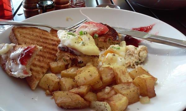 Crab Benedict. A luscious crab patty with poached egg and Hollandaise. Served with yummy country fried potatos, toast and jam