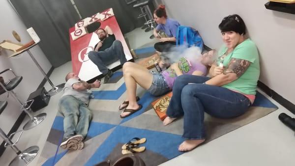 Some of our regulars hanging out in the lounge. We have chairs they just don't use them. The giant cornhole board was for one of our parties