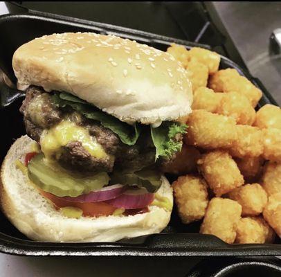 Juicy Lucy with tater tots. Juicy Lucy is a burger with cheese cooked in between the patties.