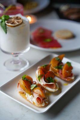 grilled peach + whipped lemon ricotta, prosciutto, basil, chili oil