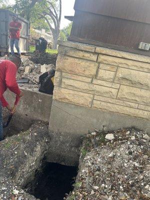 First phase:  digging holes to allow for placement of concrete cylinders which will then be compressed with a hydraulic machine to lift fndn