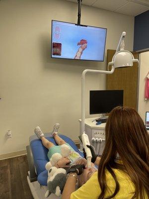 Cutting edge technology. Making a 3D scan of her teeth.