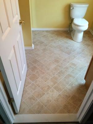 6x6 ceramic tile on a 45 degree angle  and a water saving Kohler toilet