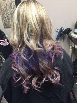 Purple and pink ombre peekaboo highlights.