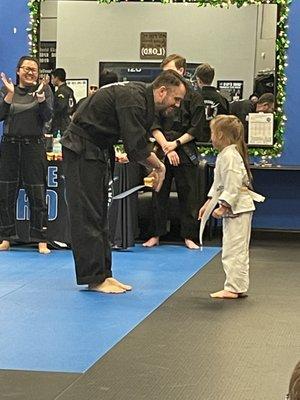 Our Granddaughter getting her orange belt.