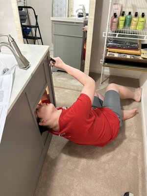 Grandson 1 installing a new faucet.