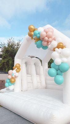 "Double Dipper" white bounce house with balloon garland. This can be transformed for a birthday, baby shower, photoshoot, etc..