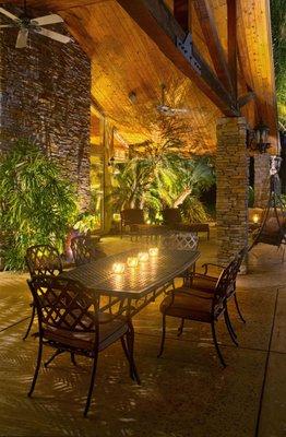 Pleasant outdoor patio highlighted by the warmth of wood and spreading shadows across the ceiling.