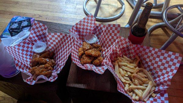 Wings with El Papacito (spicy garlic) and El Sabroson (tamarind honey) sauces and side of fries.