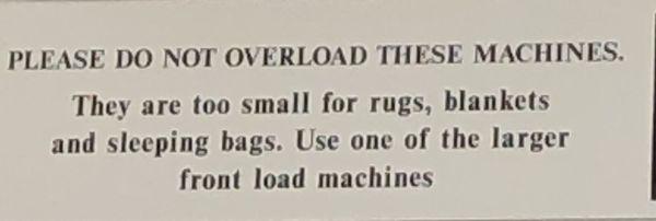 Sign in the laundromat advising to use the larger washers rugs and blankets.