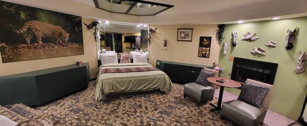 King Bed with overhead Mirrors and Behind Mirrors with Fireplace