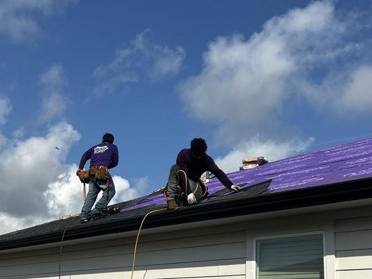 Mammoth crew working hard at it!! Nice, thick starter strip at bottom of ridge before laying shingles!