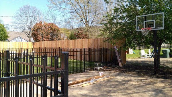 4' high black ornamental aluminum and 8' high cedar wood privacy fence