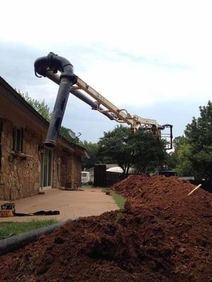 Concrete pump truck in use for a difficult to access site.