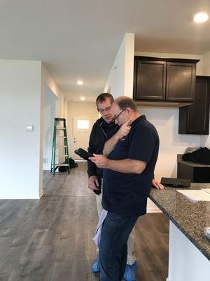 A Inspector and his Associate reviewing findings in a new construction home.