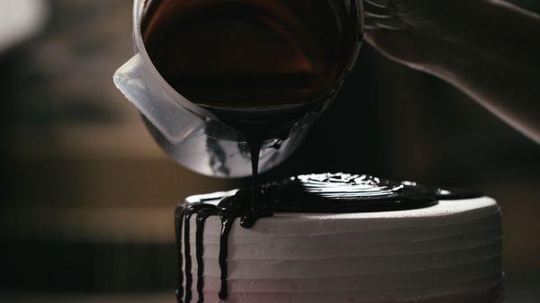 Blulight Films San Diego Video Production company filming a close up of chocolate being poured on cake.