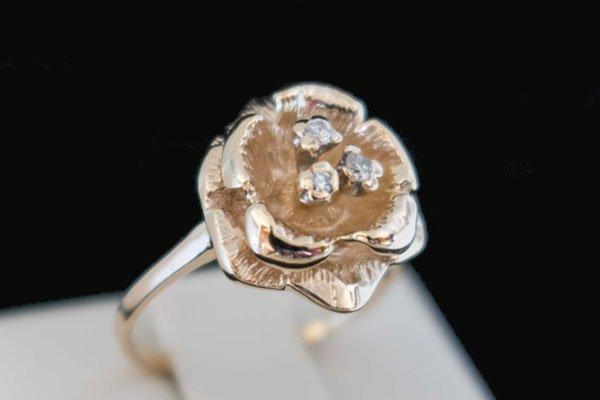 Flower ring with diamond accents.