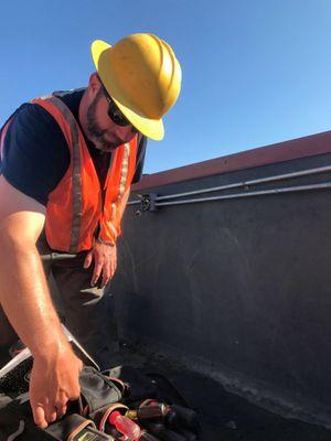 Commercial & residential roofs in Denver needed major repairs after the Spring 2017 hail storm. Here's Matt working on a local bank's roof.