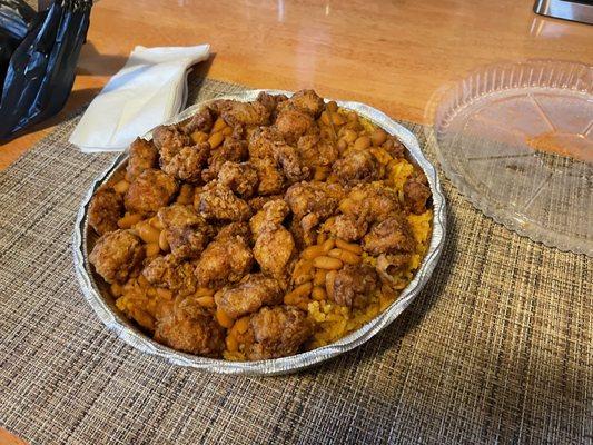 Chicken bites, yellow rice & beans underneath. (Large plate).