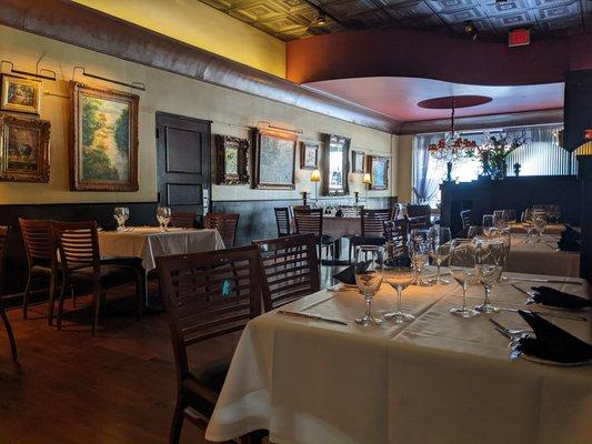 Elegant dining room, from the light fixtures to the detailed ceiling to the eclectic artwork. Such a great place to dine.