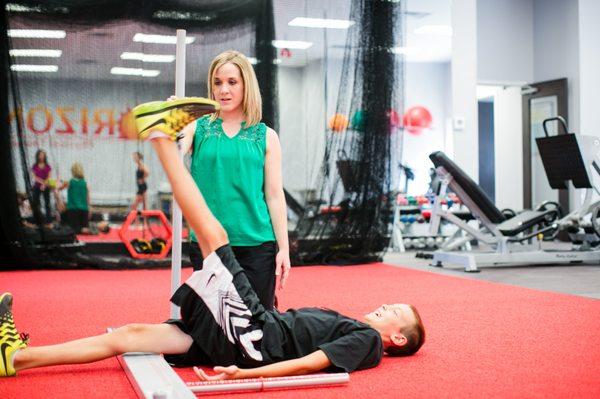 Kellie Moore, DPT performs Functional Movement Screen on baseball athlete.