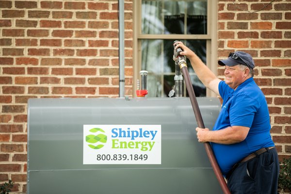 Heating Oil Delivery Driver Filling A Customer's Tank