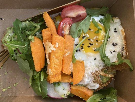 Smashed avocado on whole grain bread with added fried egg & roasted sweet potatoes.