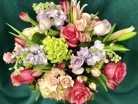 Beautiful garden mix of roses, stargazer lilies, stock, tulips, and more.