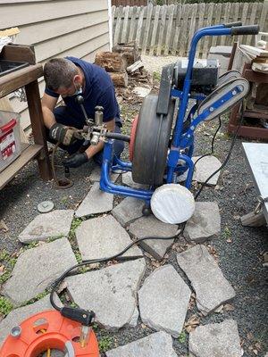 Action shot! Cleaning out clogged sewer line.